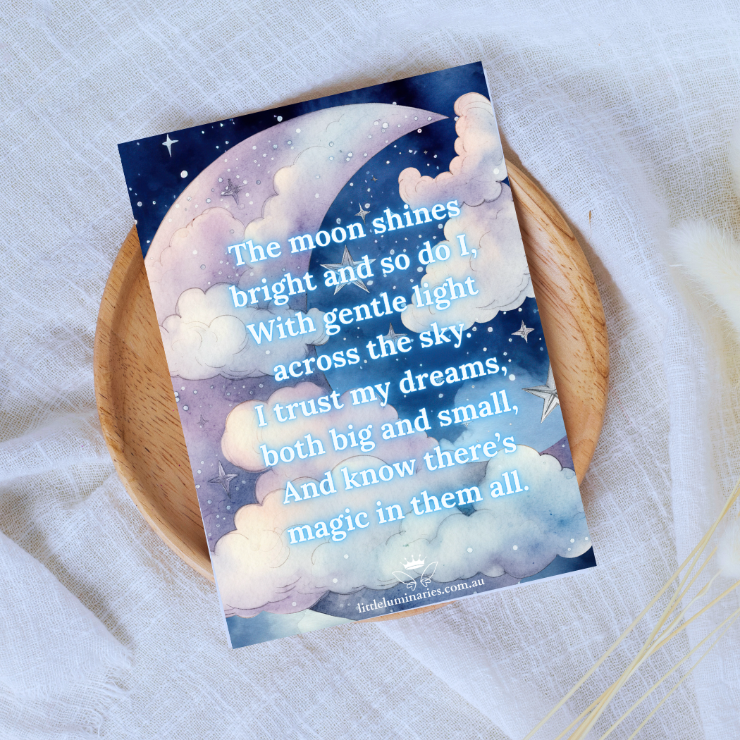 Card with moon and cloud design on a wooden plate