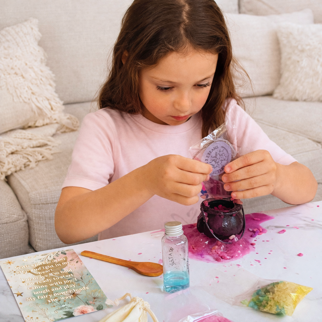 Young girl engaged in potion play with colourful materials on a table.