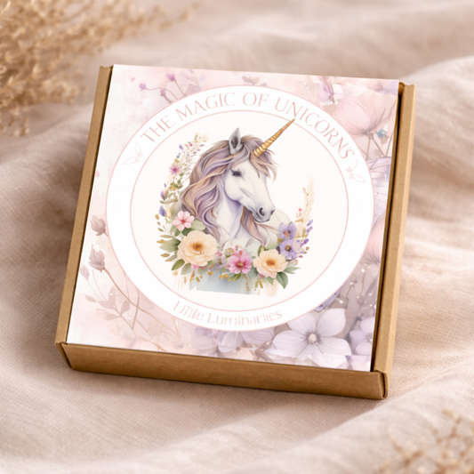 Box with unicorn illustration and 'The Magic of Unicorns' text on a soft fabric background