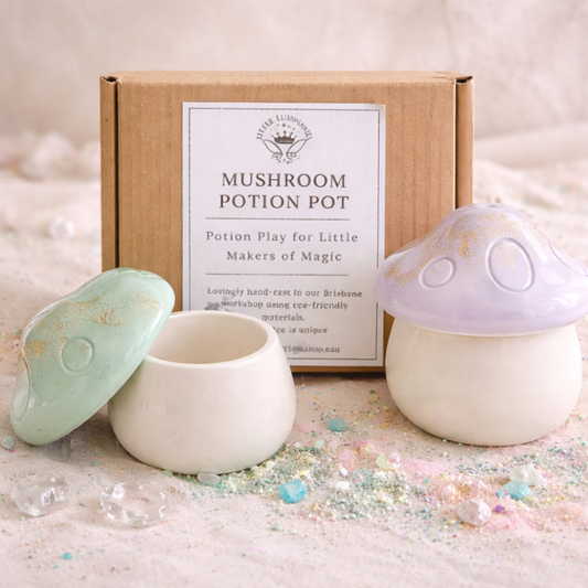 Mushroom-shaped potion pots with a box labeled 'Mushroom Potion Pot' on a soft, pastel background.