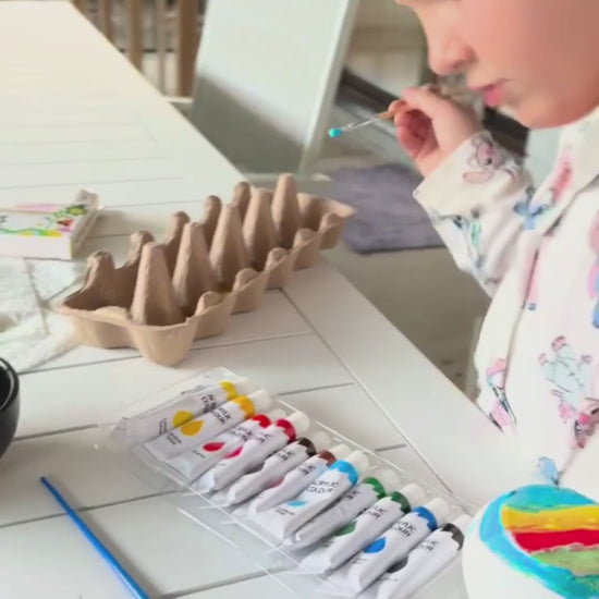 child painting a mushroom potion pot