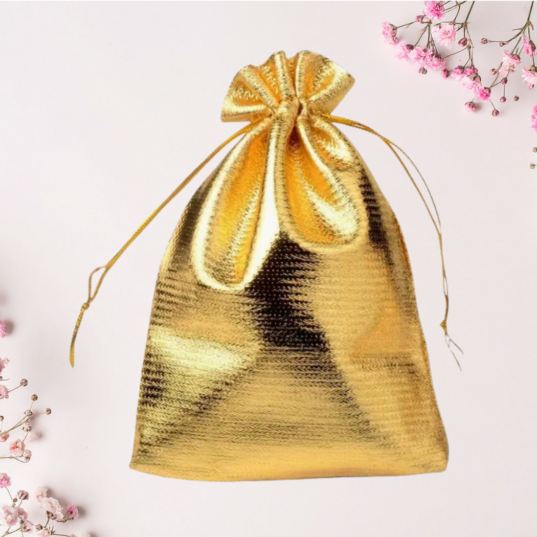 Gold drawstring pouch on a light pink background with floral elements
