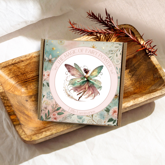 Fairy-themed product packaging on a wooden surface with decorative elements
