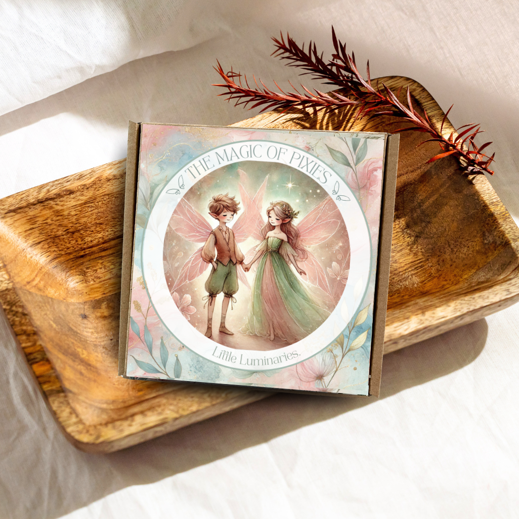 Card with fairy design on a wooden surface with feathers