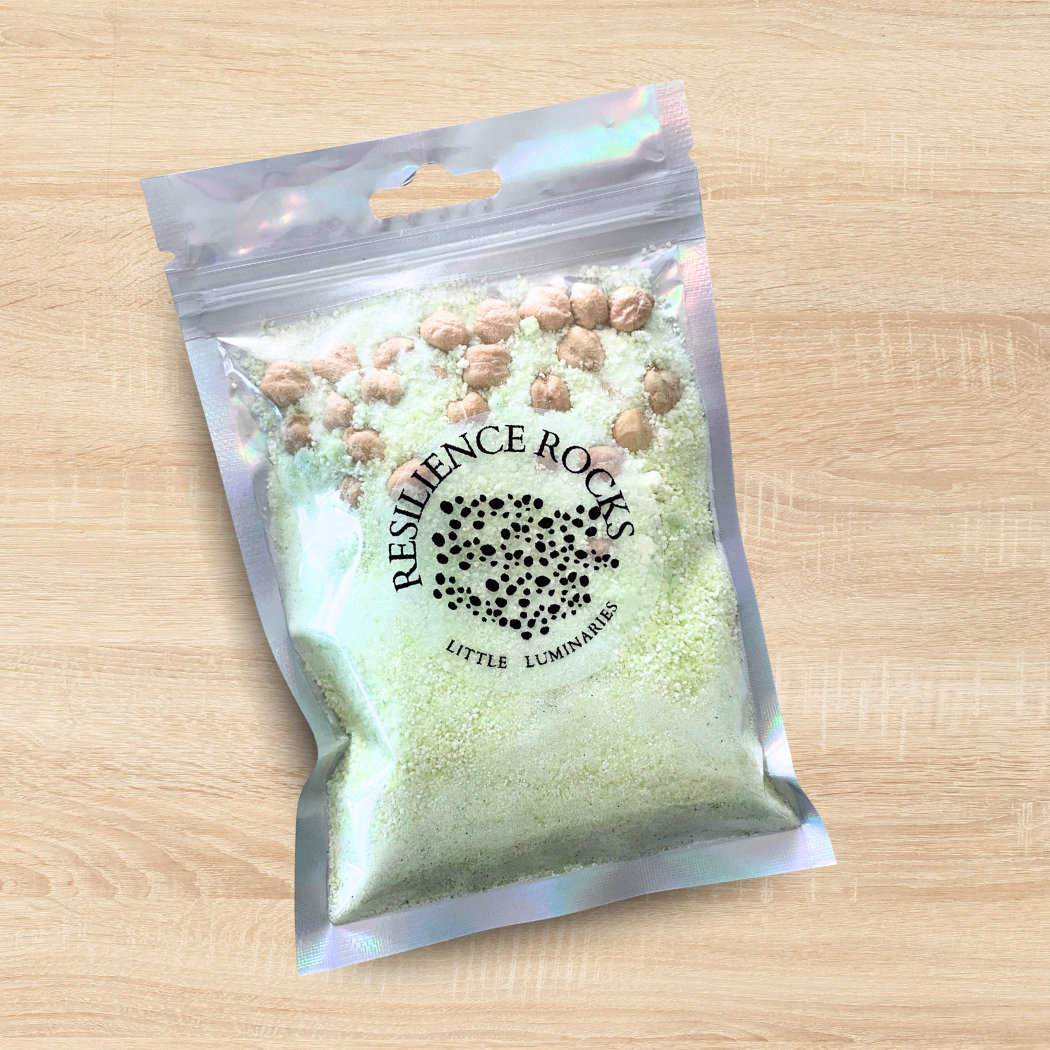 Packaged product labeled 'Resilience Rocks' on a wooden surface